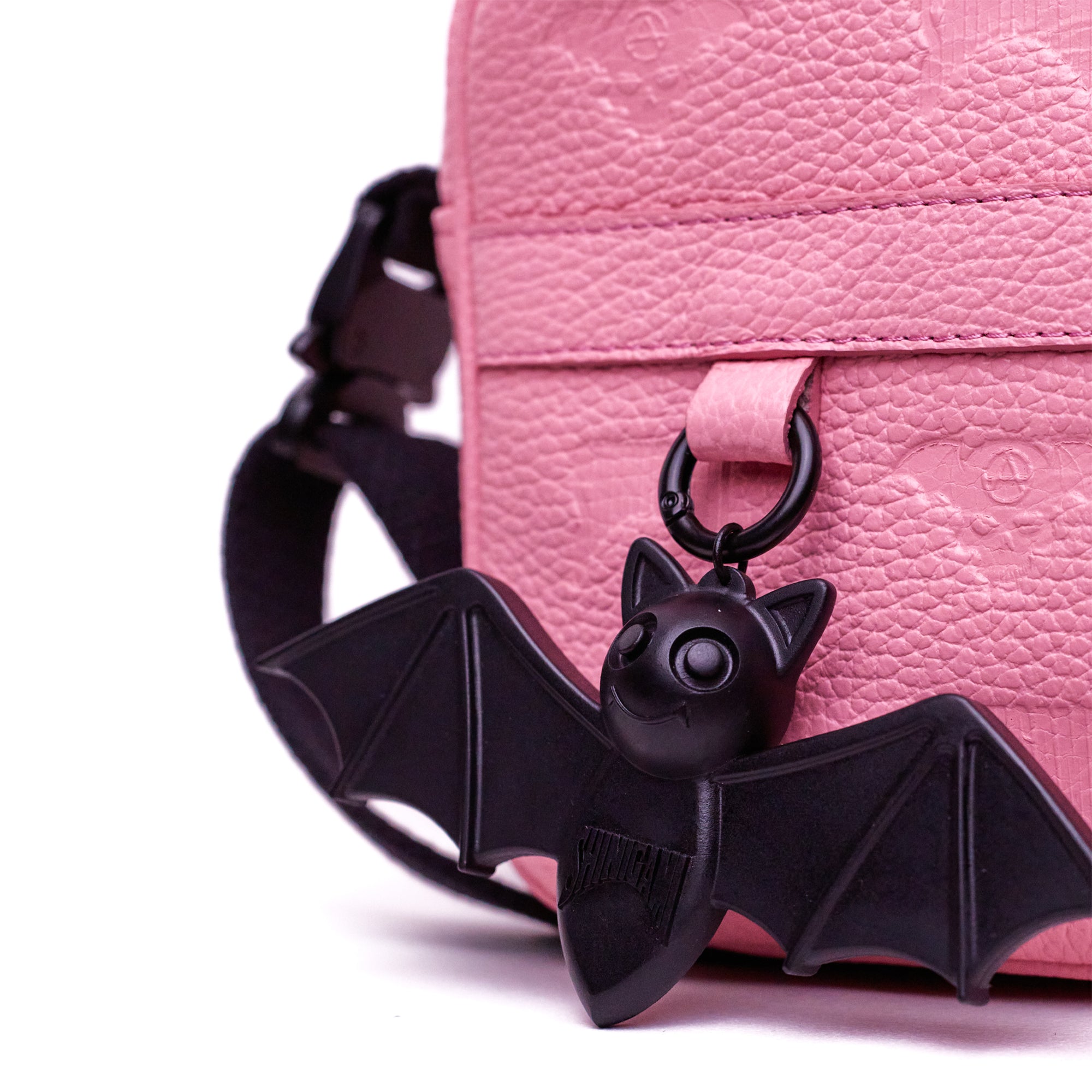 Shinigami Couture pink leather bag detail showing Beep the Bat charm and strap buckle