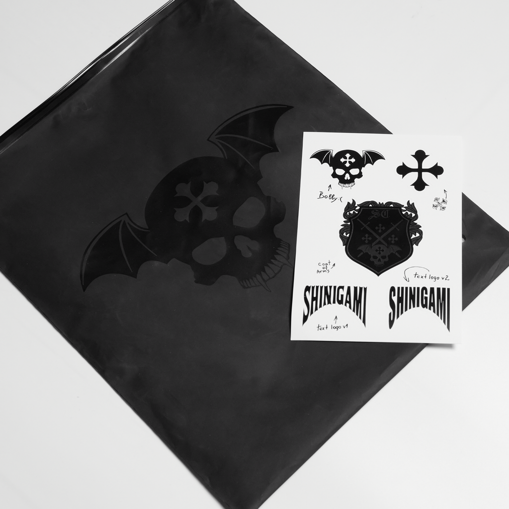 Shinigami Couture branded black packaging bag and sticker sheet pack