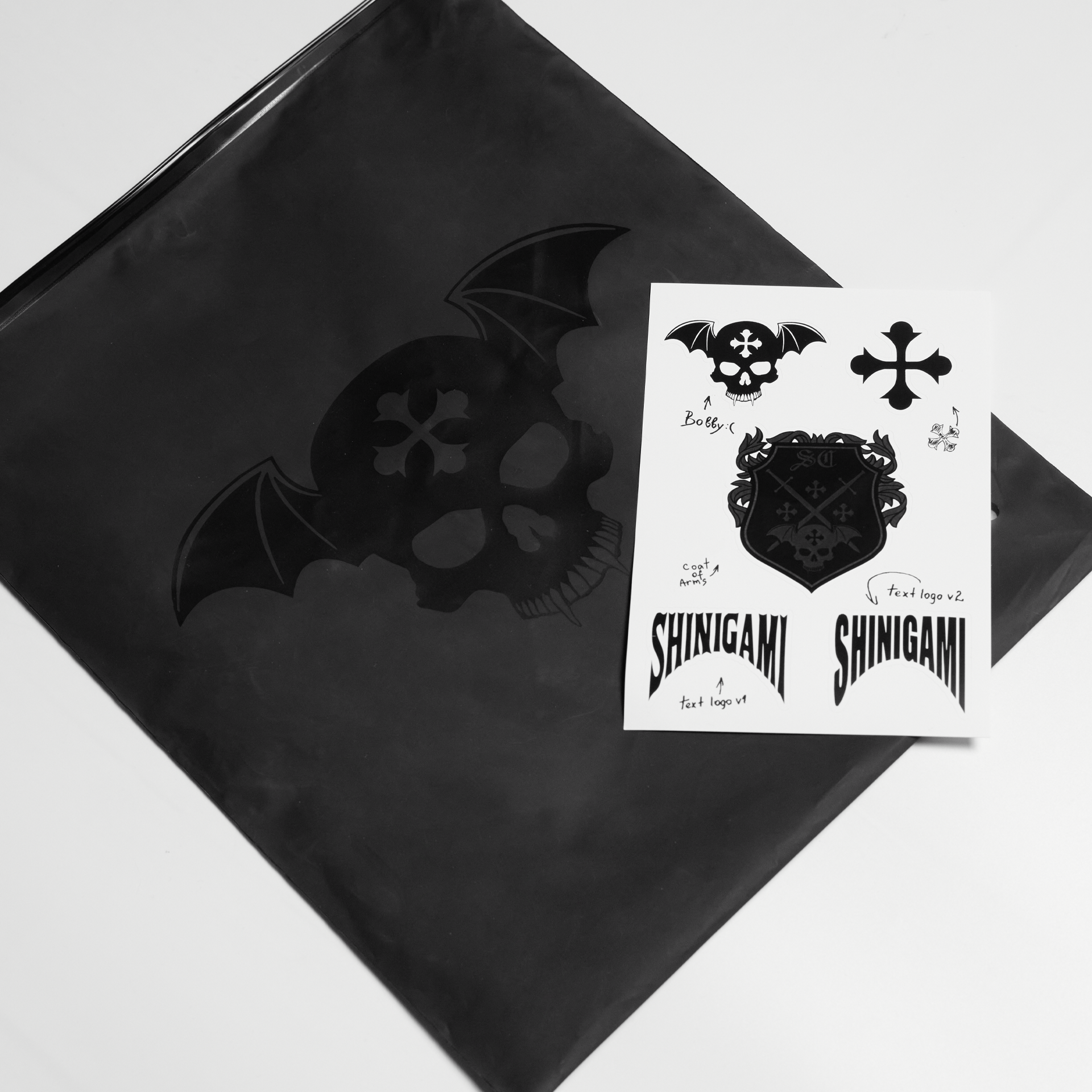 Shinigami Couture branded black packaging bag and sticker sheet pack