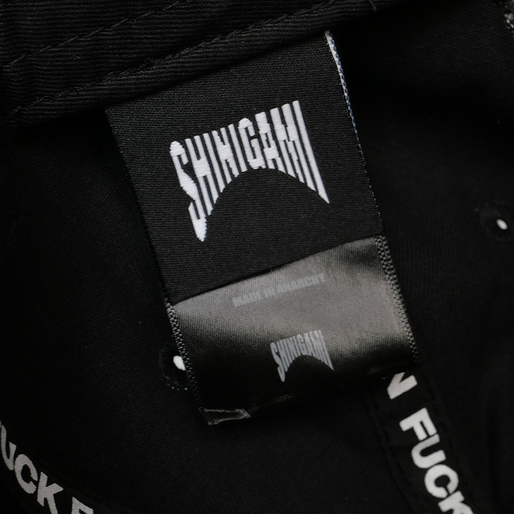 Shinigami Couture black cap interior label and branding detail