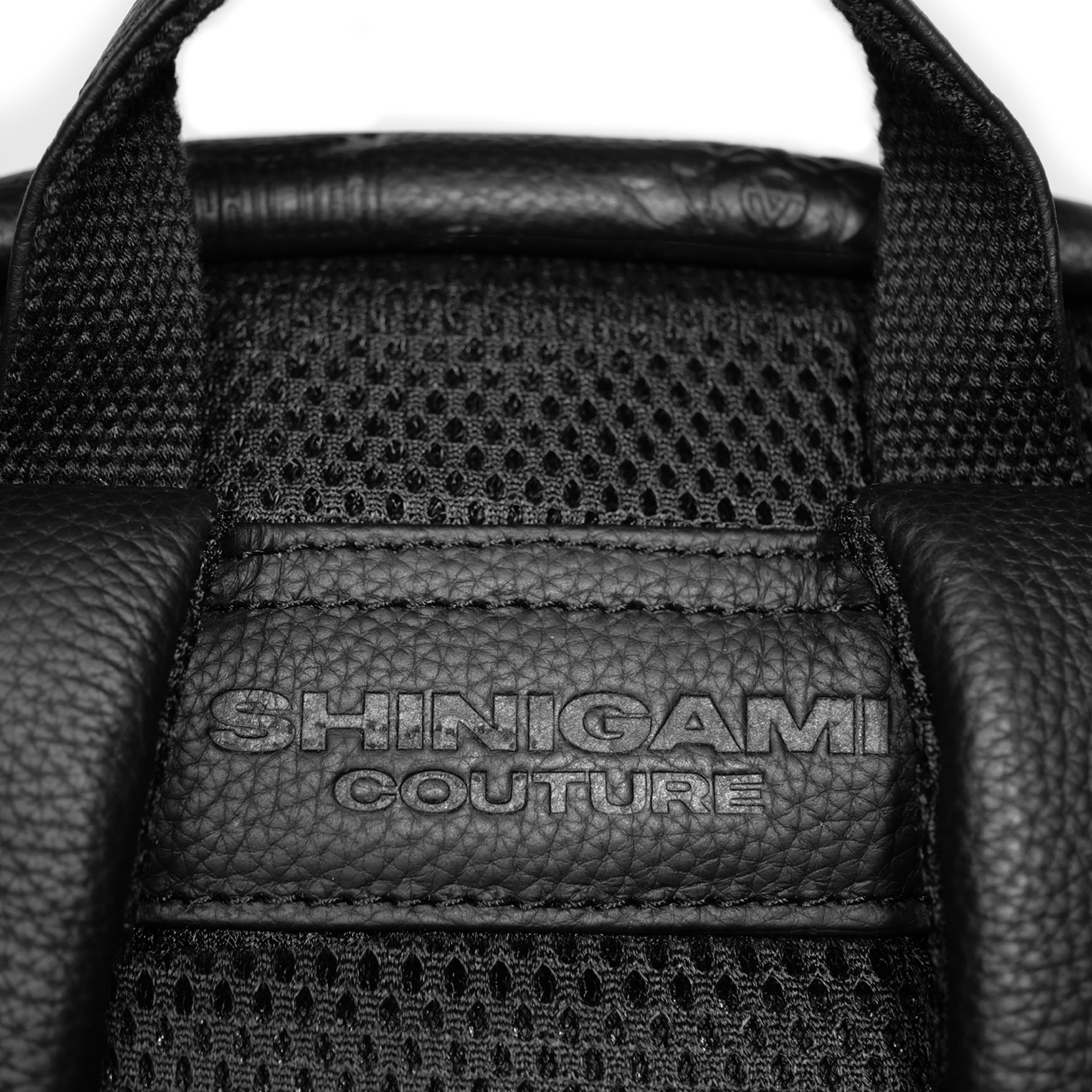 Shinigami Couture embossed leather backpack back padding and branding detail
