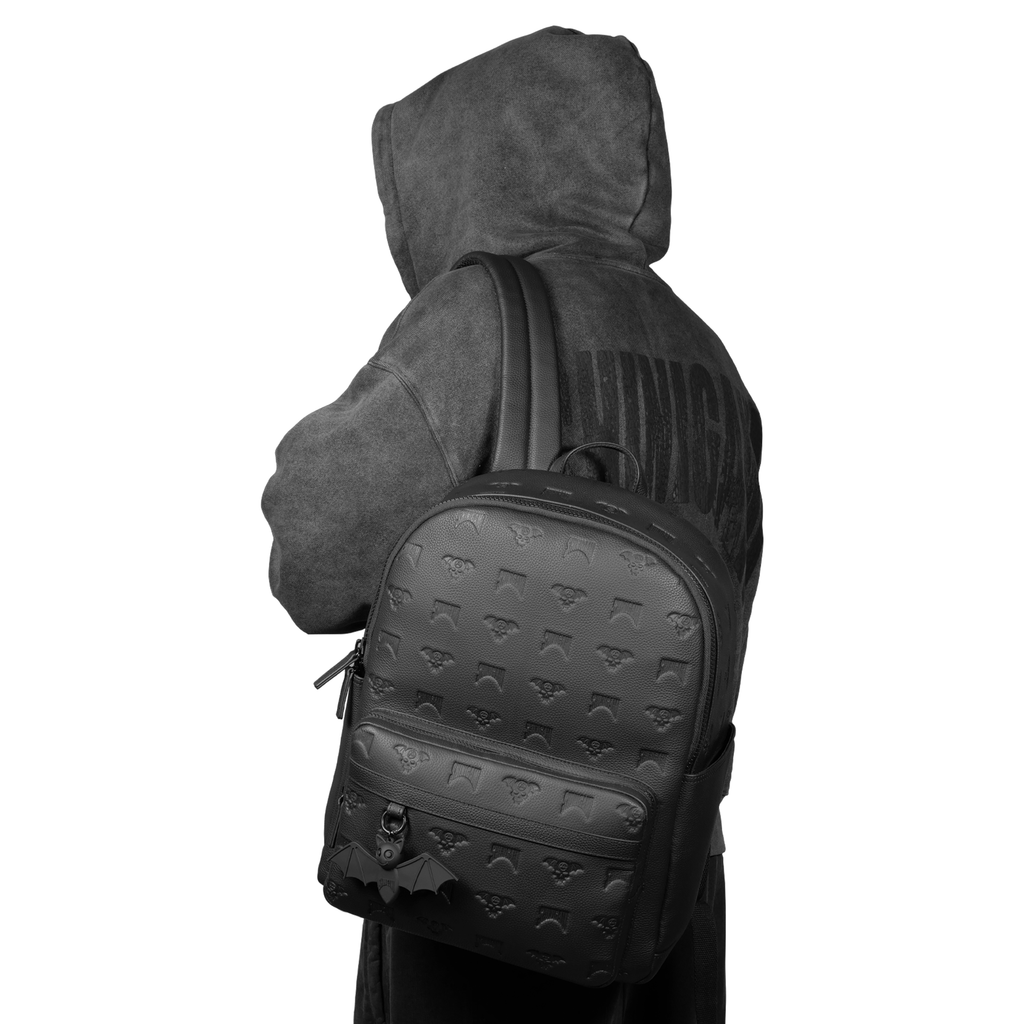 Person wearing Shinigami Couture black leather backpack with dark hoodie