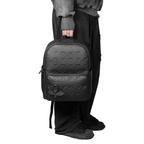 Person holding Shinigami Couture embossed leather backpack
