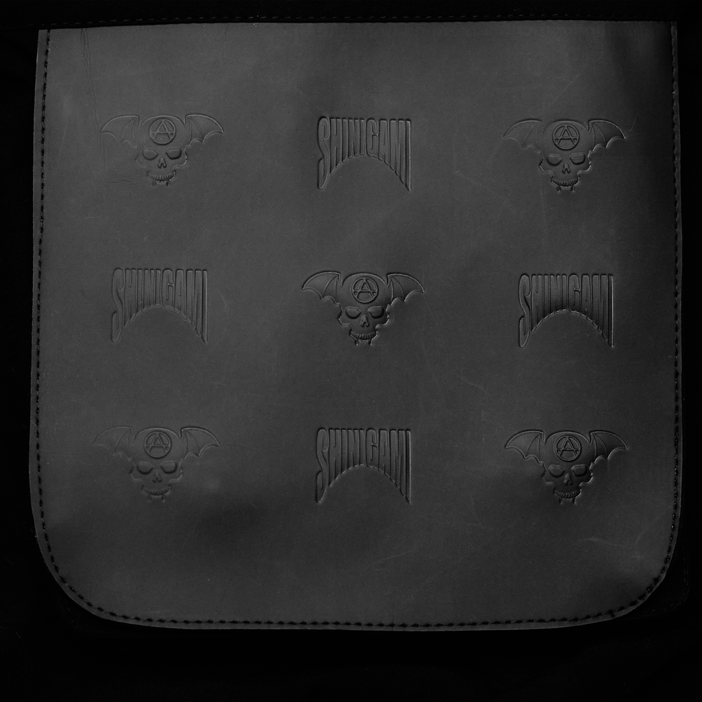 Close-up of Shinigami Couture monogram pattern texture on windbreaker fabric