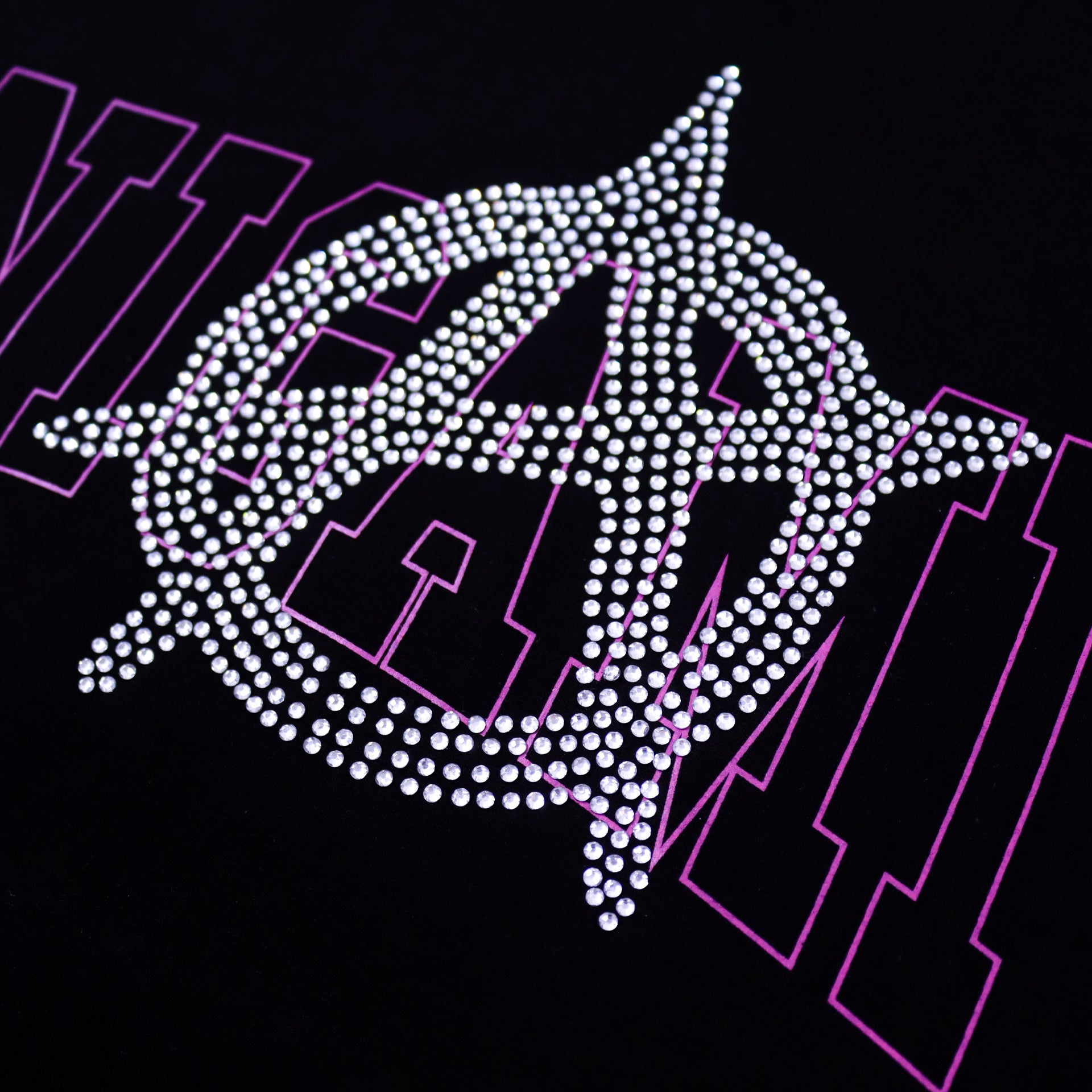 Close-up of Shinigami Couture rhinestone anarchy logo and silkscreen print detail